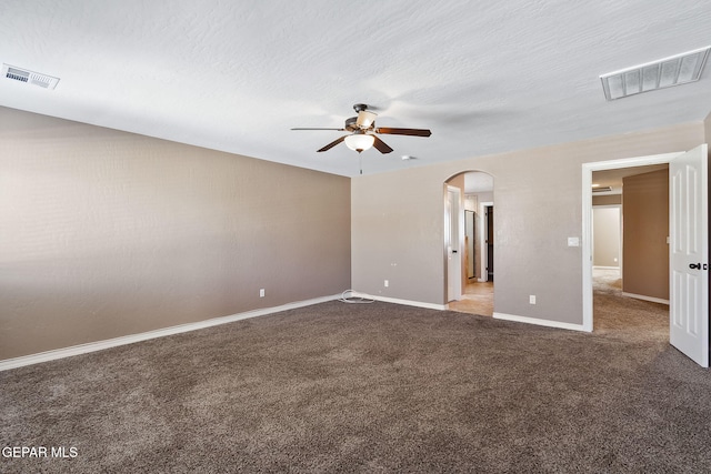 empty room with ceiling fan, carpet, and a textured ceiling