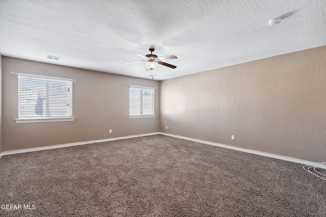 unfurnished room featuring carpet flooring, ceiling fan, and a textured ceiling