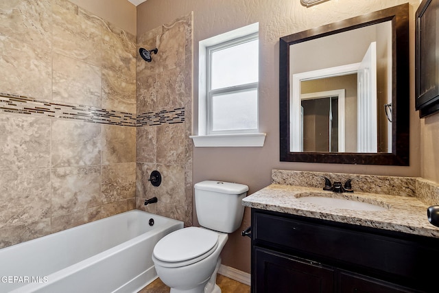 full bathroom with vanity, toilet, and tiled shower / bath