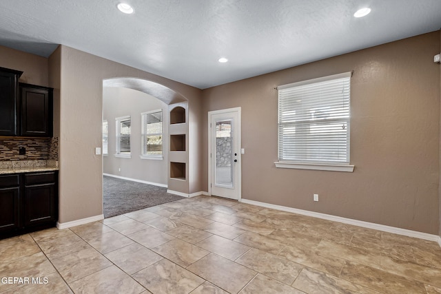 foyer entrance featuring a textured ceiling