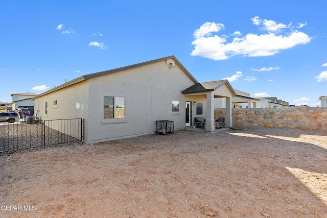 rear view of property featuring a patio