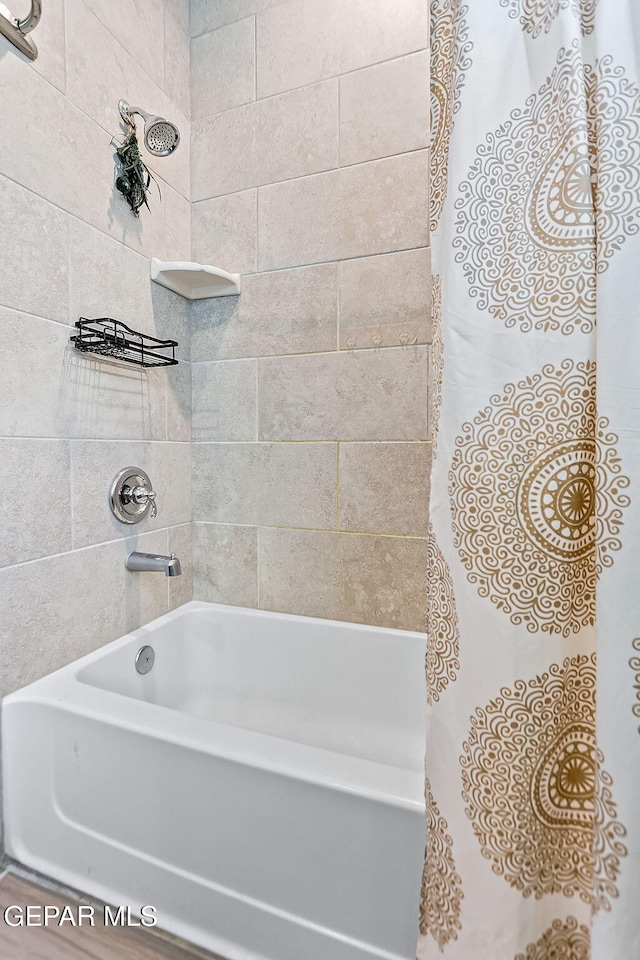 bathroom featuring shower / bathtub combination with curtain