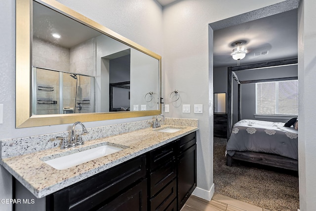 bathroom featuring vanity and an enclosed shower