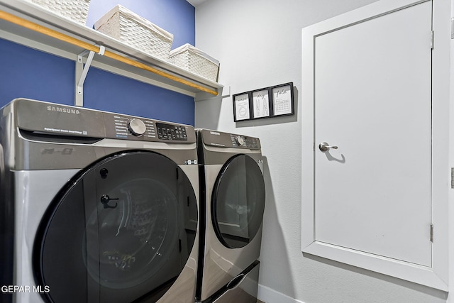 clothes washing area with washing machine and clothes dryer