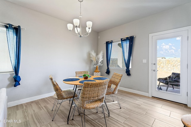 dining area featuring a chandelier and light hardwood / wood-style floors