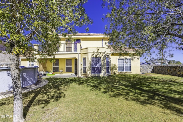 4228 Marcus Uribe Dr, El Paso, TX 79934 - back of house featuring a balcony, stucco siding, a lawn, and a tile roof