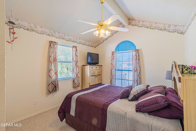 bedroom featuring a textured ceiling, lofted ceiling with beams, carpet floors, and ceiling fan