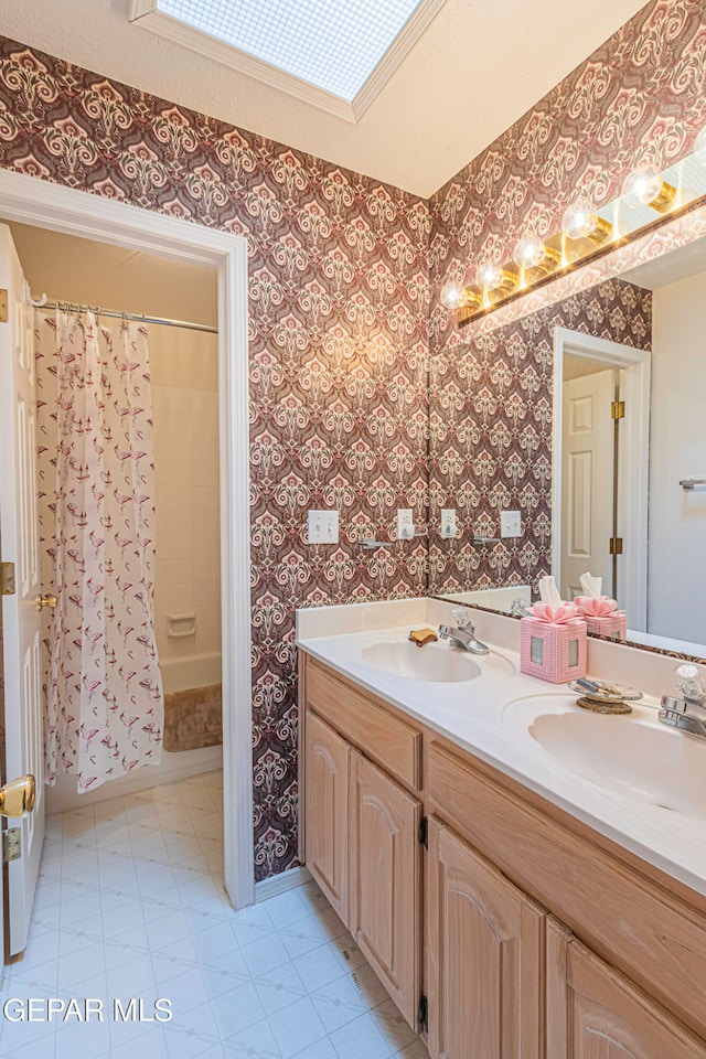 bathroom featuring shower / bath combo and vanity