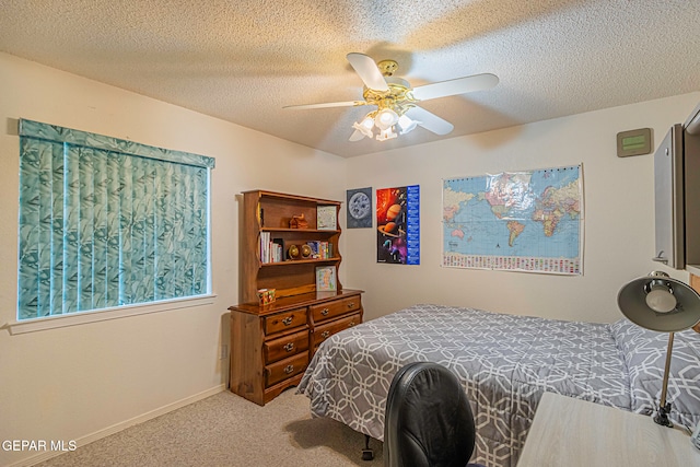 bedroom featuring carpet flooring, a textured ceiling, and ceiling fan