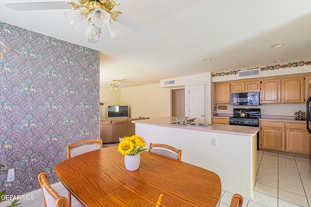 kitchen featuring black appliances, a center island with sink, sink, ceiling fan, and light tile patterned floors