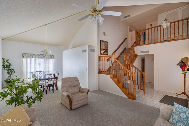 living room featuring light carpet, a textured ceiling, high vaulted ceiling, and ceiling fan