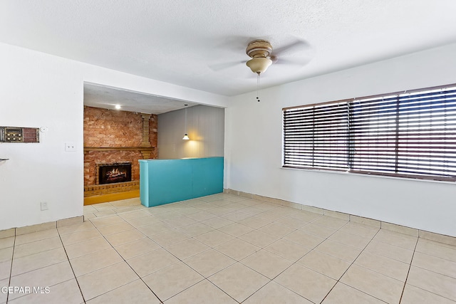 unfurnished living room featuring a textured ceiling, light tile patterned flooring, and a fireplace