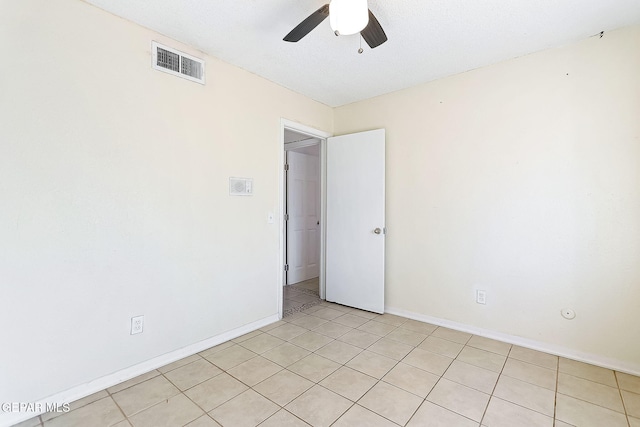 tiled empty room with ceiling fan