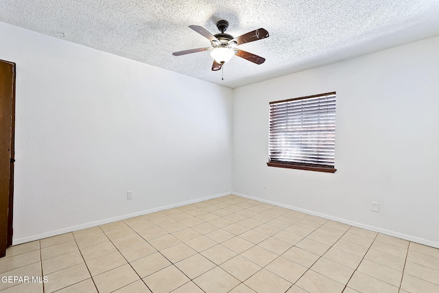 tiled spare room with a textured ceiling and ceiling fan