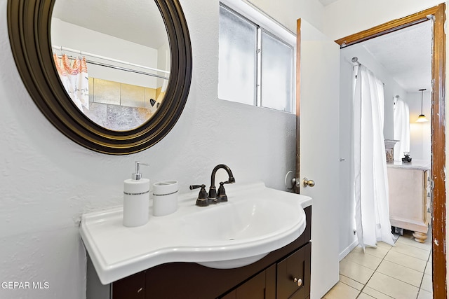 bathroom with tile patterned flooring and vanity