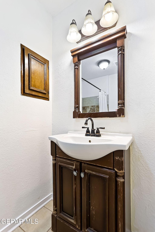 bathroom with tile patterned flooring, vanity, and a shower with shower curtain