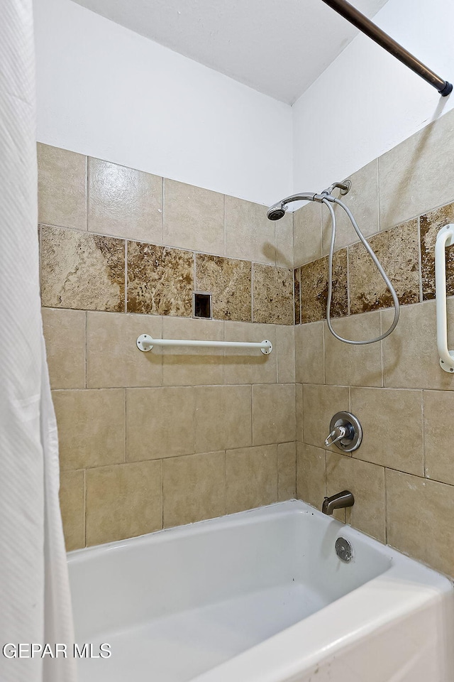 bathroom with shower / tub combo with curtain