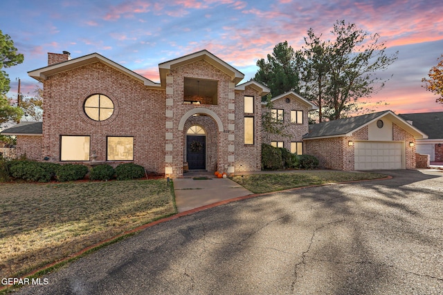 view of front facade with a lawn and a garage