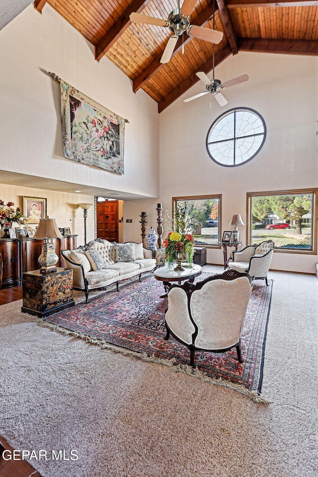 carpeted living room with beamed ceiling, high vaulted ceiling, ceiling fan, and wooden ceiling