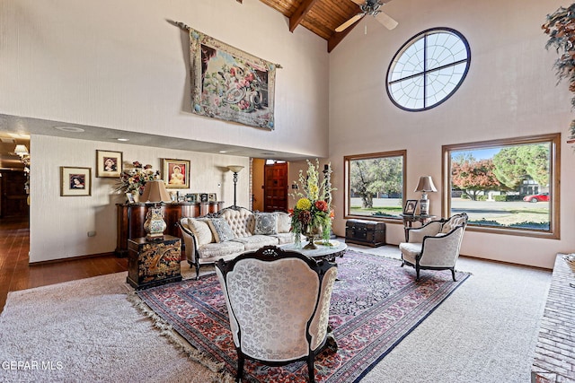 living room with wood ceiling, ceiling fan, high vaulted ceiling, beamed ceiling, and hardwood / wood-style floors