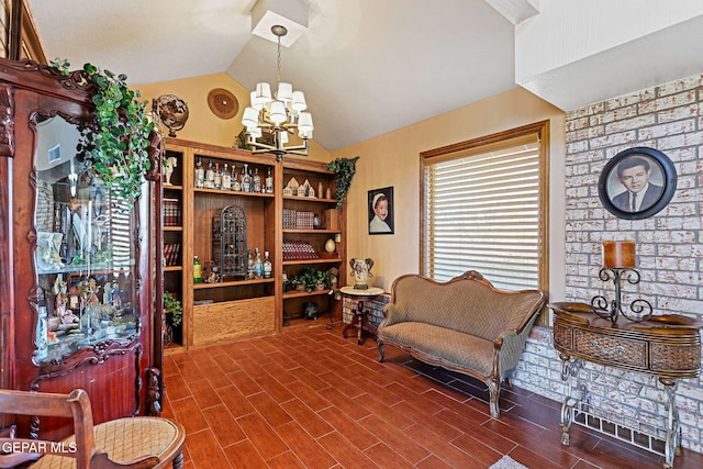 sitting room featuring hardwood / wood-style floors, a notable chandelier, and lofted ceiling