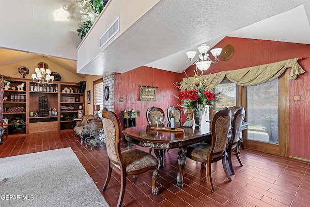 dining room featuring a textured ceiling, dark hardwood / wood-style floors, vaulted ceiling, and a notable chandelier