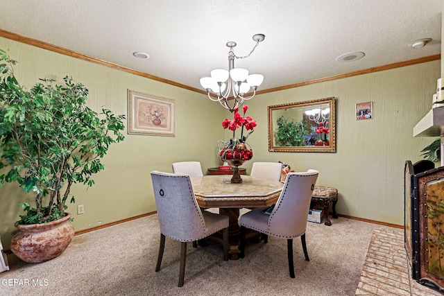 dining space with carpet flooring, a textured ceiling, a chandelier, and ornamental molding