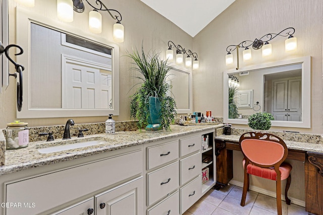 bathroom featuring tile patterned flooring, vanity, and lofted ceiling