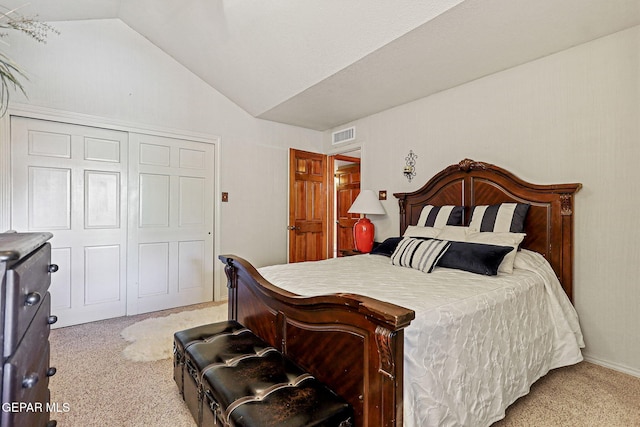 carpeted bedroom featuring a closet and vaulted ceiling