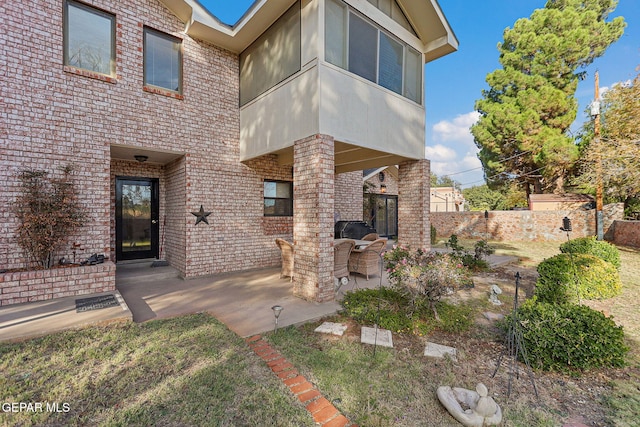 entrance to property featuring a patio