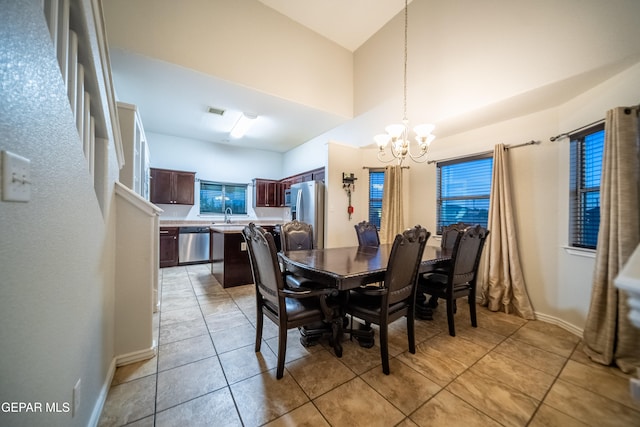 dining area with sink, light tile patterned flooring, and a notable chandelier