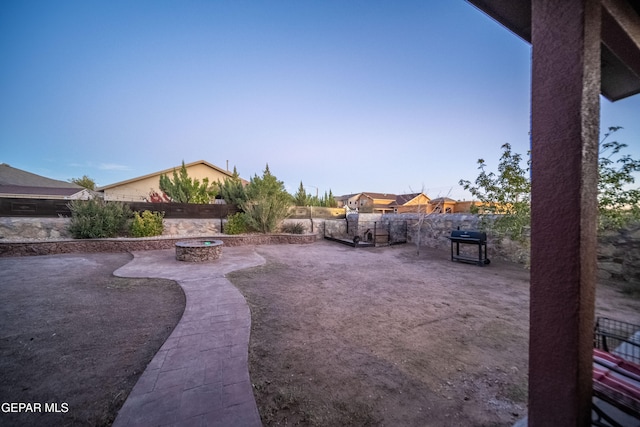 view of yard featuring a patio and an outdoor fire pit