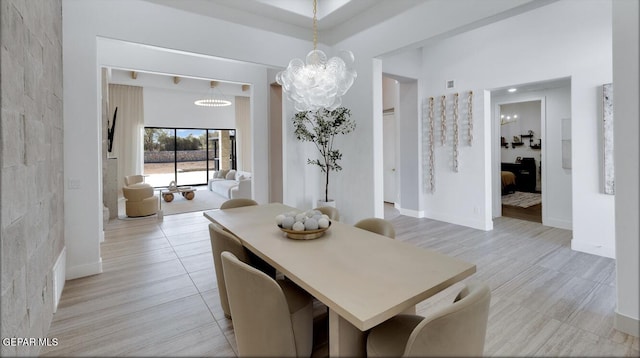 dining room featuring a notable chandelier and light wood-type flooring