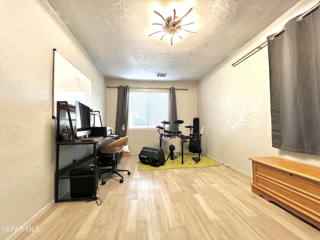 office featuring a textured ceiling and light hardwood / wood-style flooring