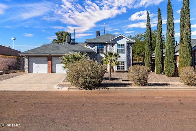 view of front of house featuring a garage and central air condition unit