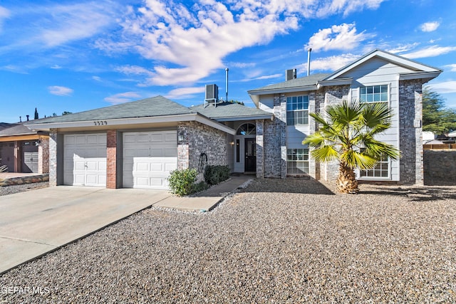 view of front of home featuring cooling unit and a garage