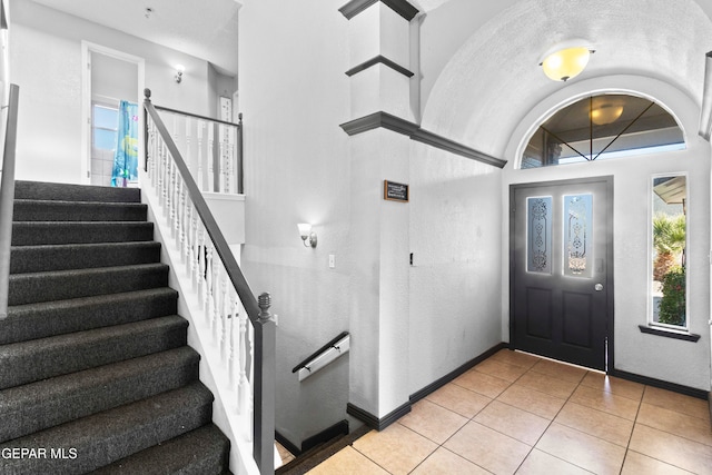 entrance foyer featuring a wealth of natural light, light tile patterned floors, and a textured ceiling