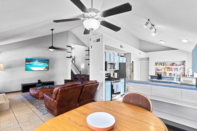 dining space with light tile patterned floors, a textured ceiling, vaulted ceiling, and ceiling fan