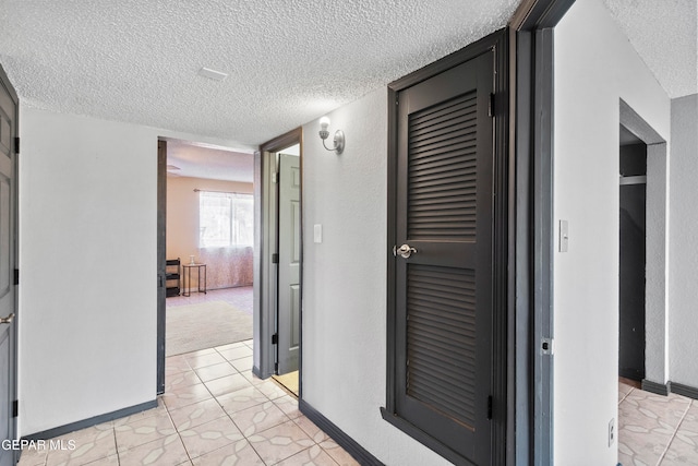 hallway with a textured ceiling