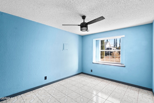 spare room featuring ceiling fan and a textured ceiling