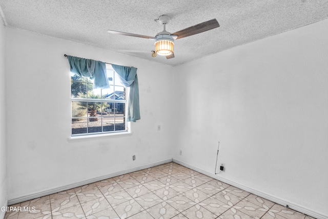 spare room with ceiling fan and a textured ceiling