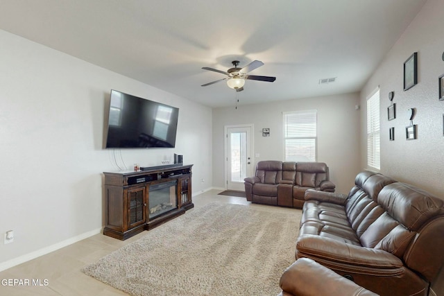 living room featuring light tile patterned floors and ceiling fan