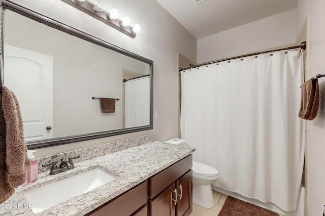 bathroom featuring tile patterned floors, vanity, and toilet