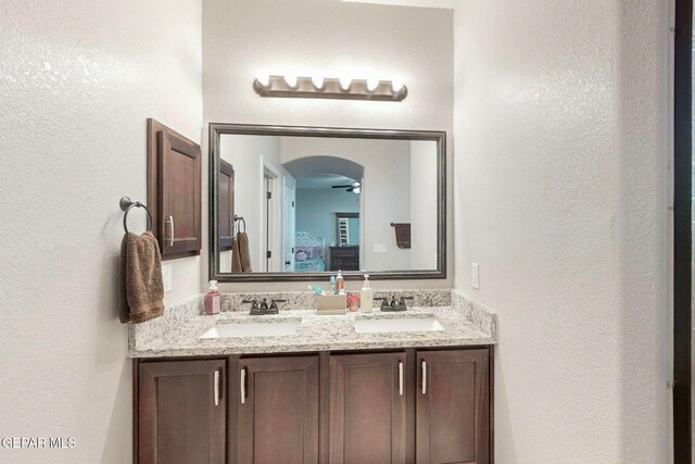 bathroom with ceiling fan and vanity