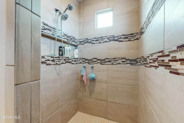 bathroom with a tile shower