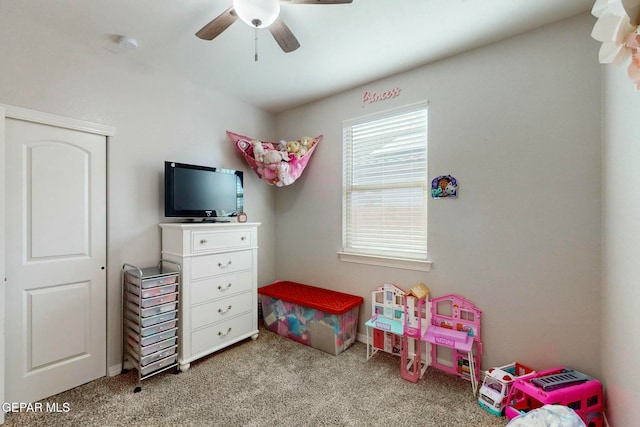 playroom with ceiling fan and light carpet