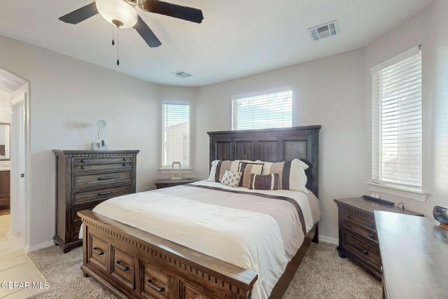 bedroom with ceiling fan and light colored carpet