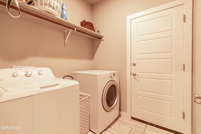 clothes washing area with washing machine and clothes dryer