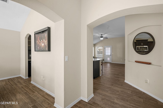 hall featuring dark hardwood / wood-style flooring and lofted ceiling