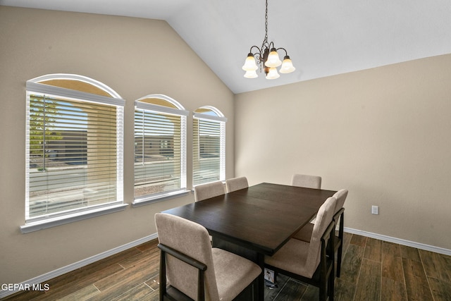 dining space featuring vaulted ceiling, dark wood-type flooring, and a notable chandelier